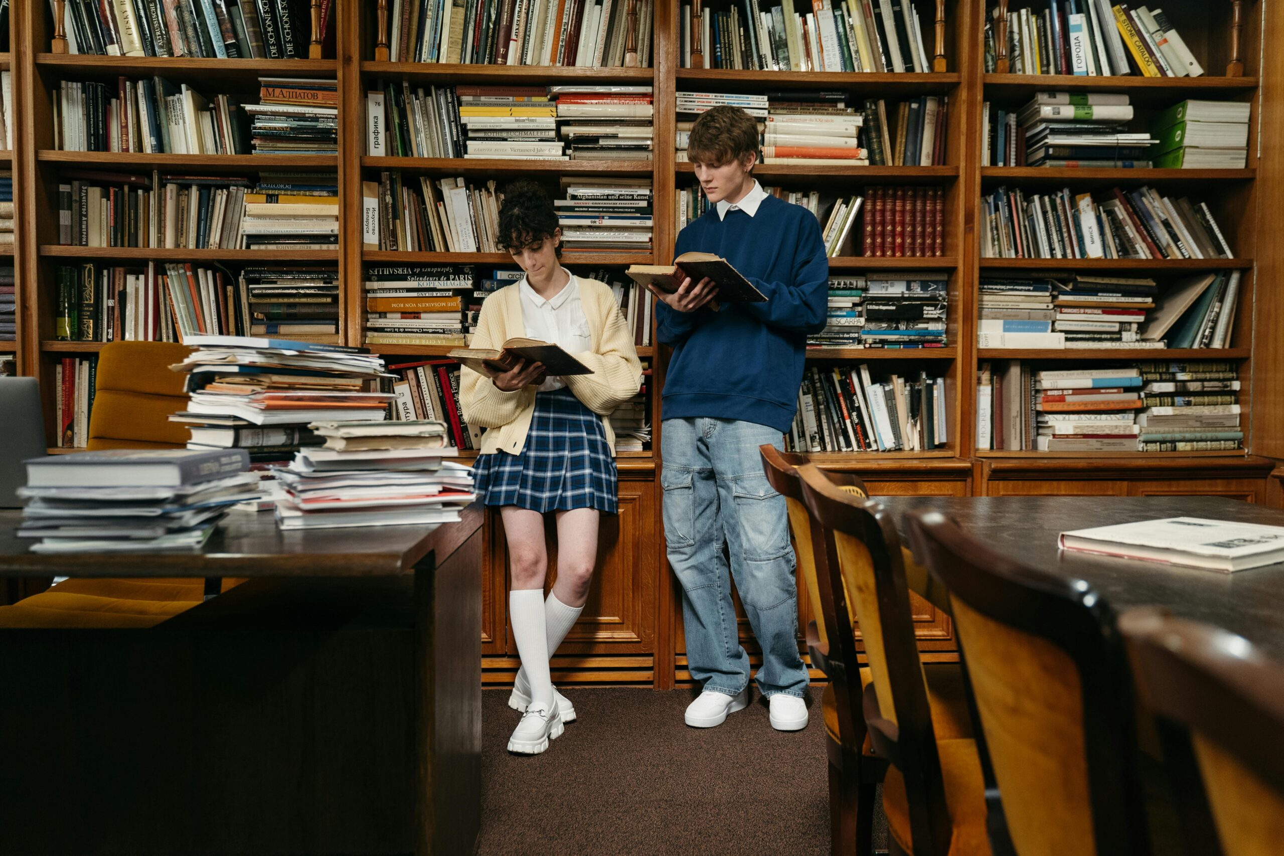 students holding books in a library